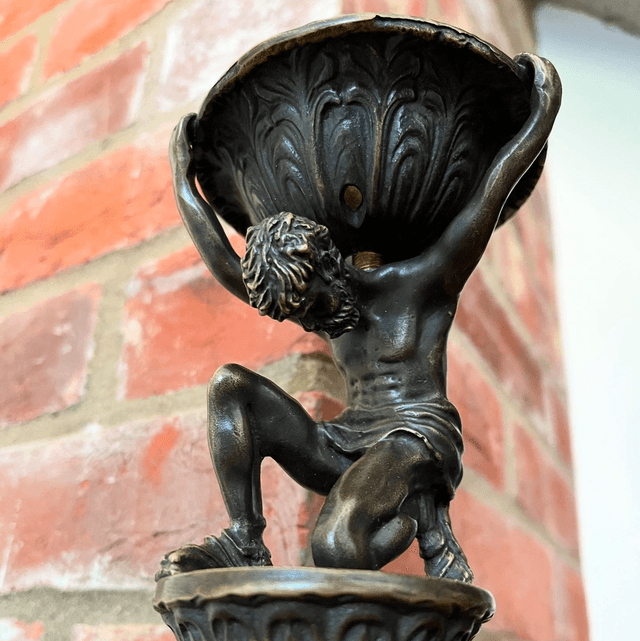 A Bronzed Metal Table Lamp Of Atlas