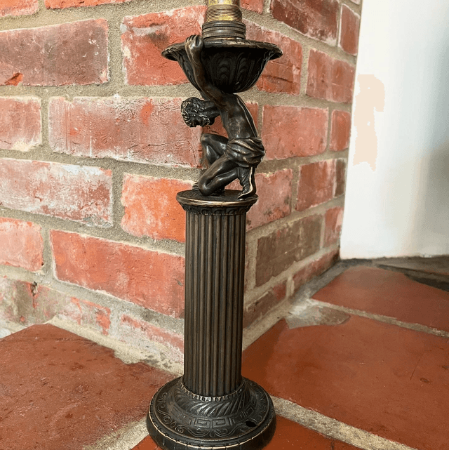 A Bronzed Metal Table Lamp Of Atlas