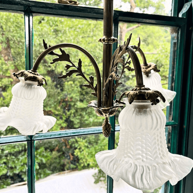 A 19th Century Brass Three Arm Chandelier With French Tulip Glass Shades