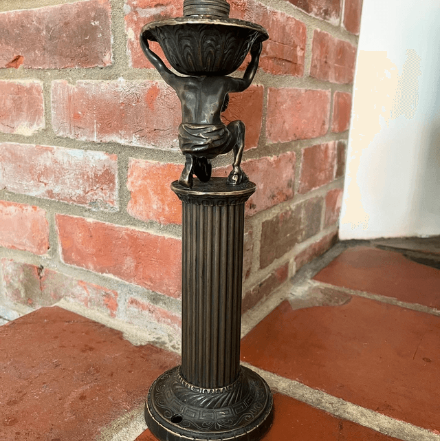 A Bronzed Metal Table Lamp Of Atlas