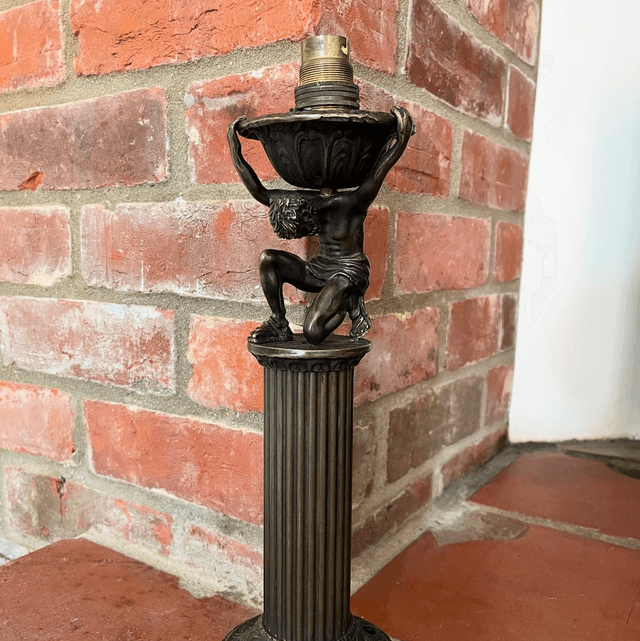 A Bronzed Metal Table Lamp Of Atlas