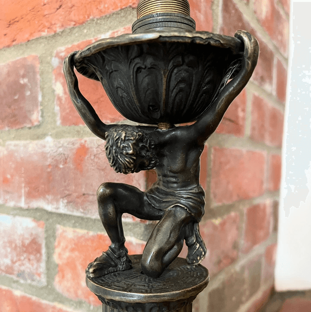 A Bronzed Metal Table Lamp Of Atlas